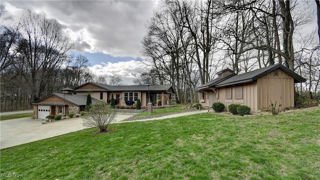 7345 Township Road 319, Millersburg, OH 44654 - view of front of house featuring a front lawn, a garage, and concrete driveway