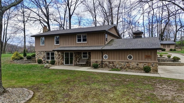 7345 Township Road 319, Millersburg, OH 44654 - back of house with a patio, a chimney, stone siding, board and batten siding, and a yard