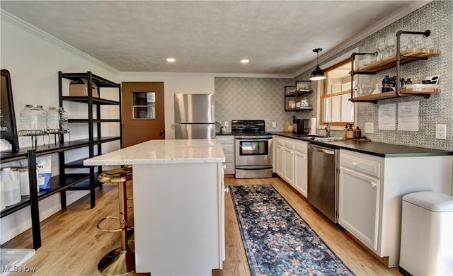 7345 Township Road 319, Millersburg, OH 44654 - kitchen featuring crown molding, appliances with stainless steel finishes, light wood-type flooring, and a kitchen island