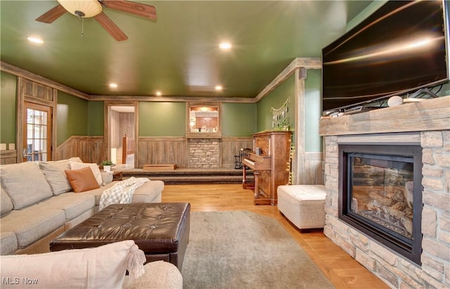 7345 Township Road 319, Millersburg, OH 44654 - living room with a stone fireplace, ornamental molding, a wainscoted wall, and ceiling fan