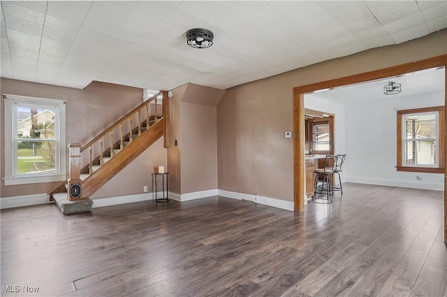 2510 E Midlothian Blvd, Youngstown, OH 44502 - unfurnished living room featuring wood finished floors, stairway, and baseboards