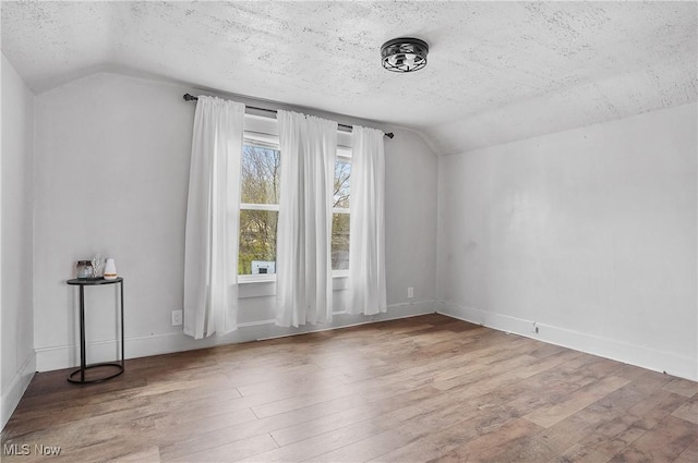 2510 E Midlothian Blvd, Youngstown, OH 44502 - bonus room featuring lofted ceiling, a textured ceiling, wood finished floors, and baseboards