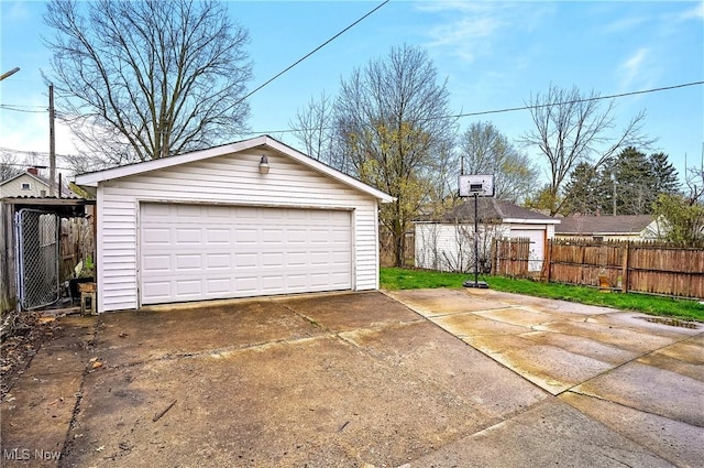 detached garage featuring fence