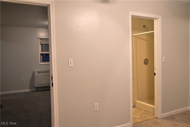 interior space featuring baseboards, heating unit, and carpet