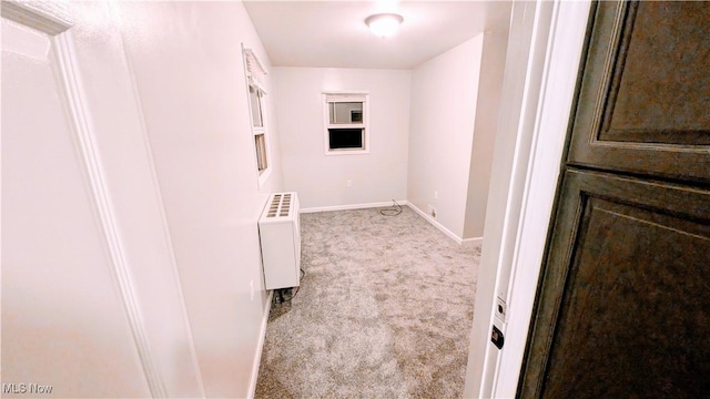 corridor featuring carpet floors and baseboards