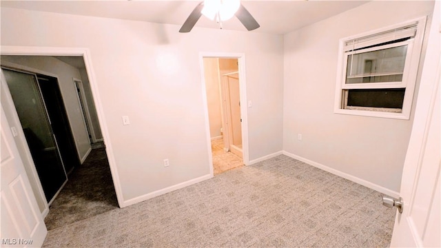 unfurnished bedroom with baseboards, a ceiling fan, and carpet flooring
