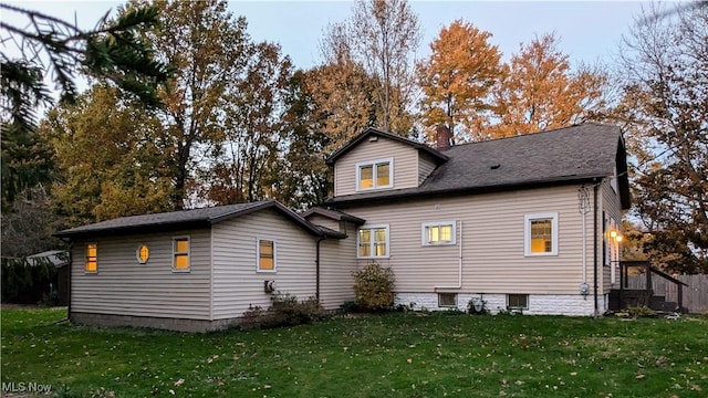 back of house with a lawn
