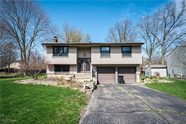 161 Bentwillow Dr, Niles, OH 44446 - bi-level home featuring an attached garage, a chimney, aphalt driveway, and a front yard
