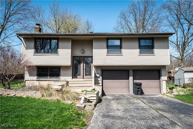 161 Bentwillow Dr, Niles, OH 44446 - split foyer home with driveway, a chimney, and an attached garage