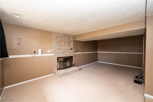 161 Bentwillow Dr, Niles, OH 44446 - basement featuring a fireplace, a textured ceiling, visible vents, carpet flooring, and baseboards