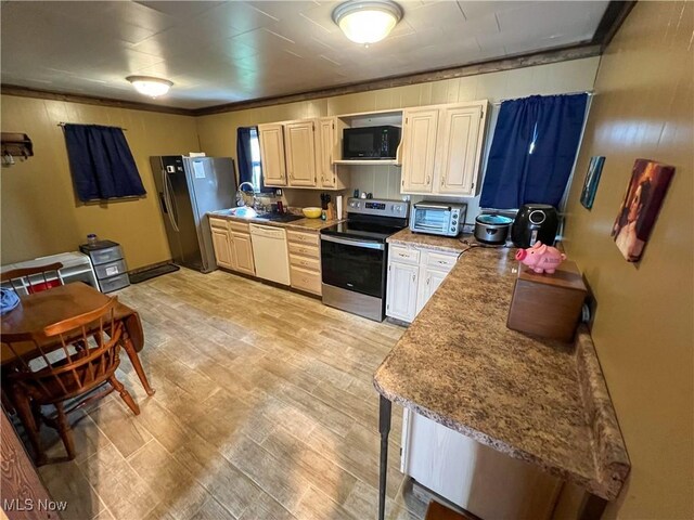 106 N Surry Rd, East Liverpool, OH 43920 - kitchen with light wood-type flooring, baseboards, and stainless steel appliances