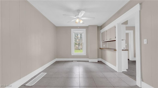 804 E Ave, Elyria, OH 44035 - spare room featuring visible vents, baseboards, a ceiling fan, and light tile patterned flooring