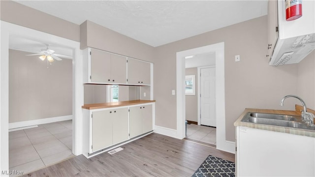 804 E Ave, Elyria, OH 44035 - kitchen featuring ceiling fan, light countertops, a sink, light wood finished floors, and baseboards
