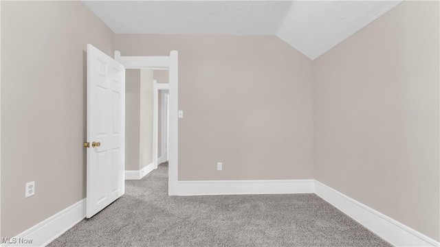 804 E Ave, Elyria, OH 44035 - carpeted spare room featuring baseboards and vaulted ceiling