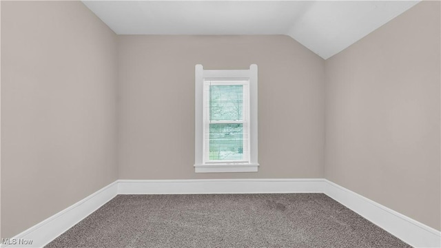 804 E Ave, Elyria, OH 44035 - empty room featuring baseboards, vaulted ceiling, and carpet floors