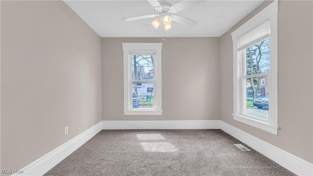 804 E Ave, Elyria, OH 44035 - carpeted empty room featuring visible vents, baseboards, and a ceiling fan