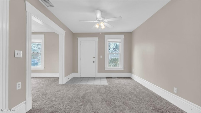 804 E Ave, Elyria, OH 44035 - carpeted foyer entrance featuring visible vents, ceiling fan, tile patterned flooring, and baseboards