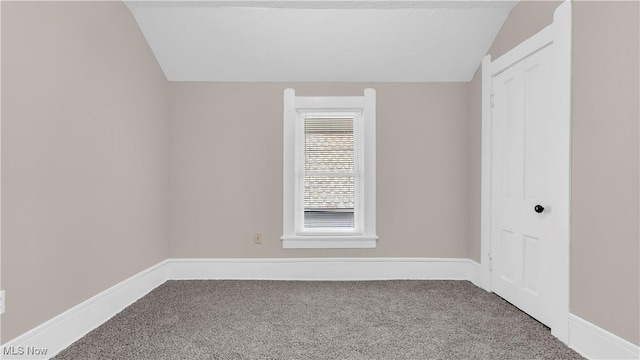 804 E Ave, Elyria, OH 44035 - spare room with baseboards, carpet, and lofted ceiling