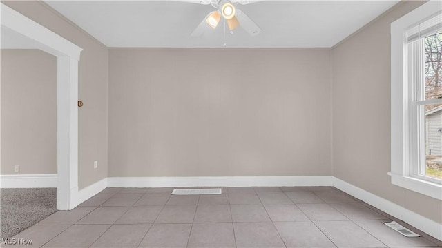 804 E Ave, Elyria, OH 44035 - empty room featuring visible vents, ceiling fan, baseboards, and light tile patterned floors