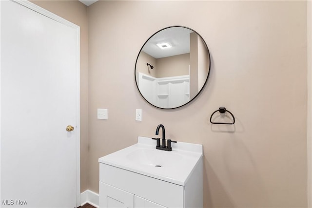 bathroom featuring baseboards and vanity