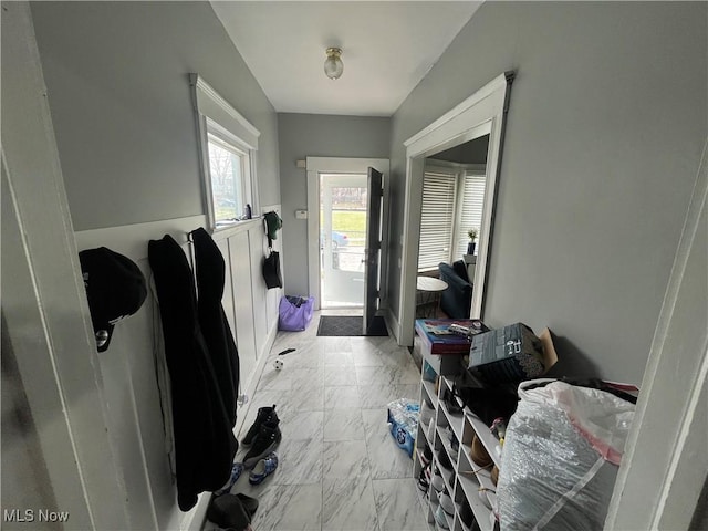 foyer featuring marble finish floor