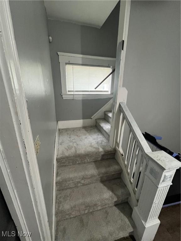 stairs with carpet flooring and baseboards