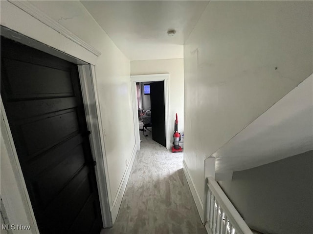 hallway featuring baseboards