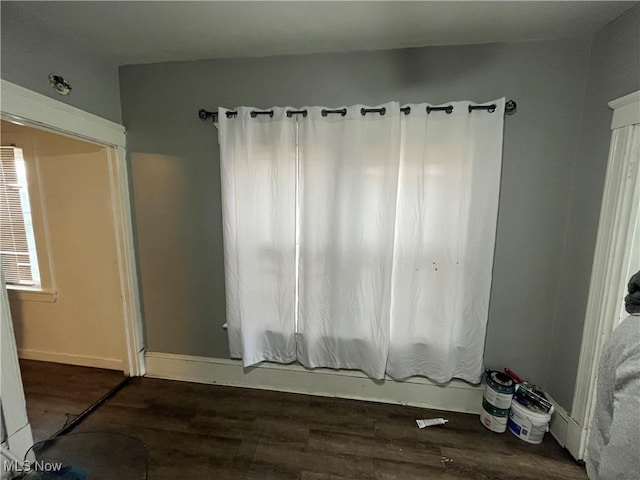 interior space with wood finished floors and baseboards