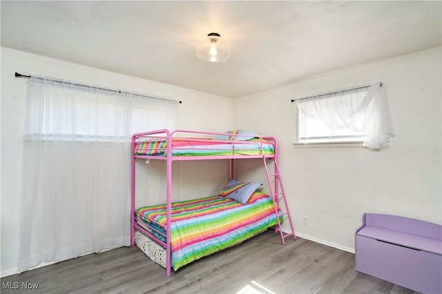 bedroom with wood finished floors and baseboards