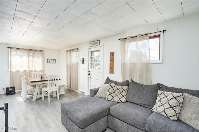 living room with wood finished floors, a wealth of natural light, and visible vents