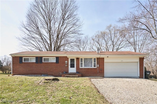 ranch-style house with a garage, gravel driveway, brick siding, and a front yard