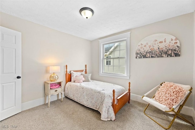 bedroom featuring baseboards and light colored carpet