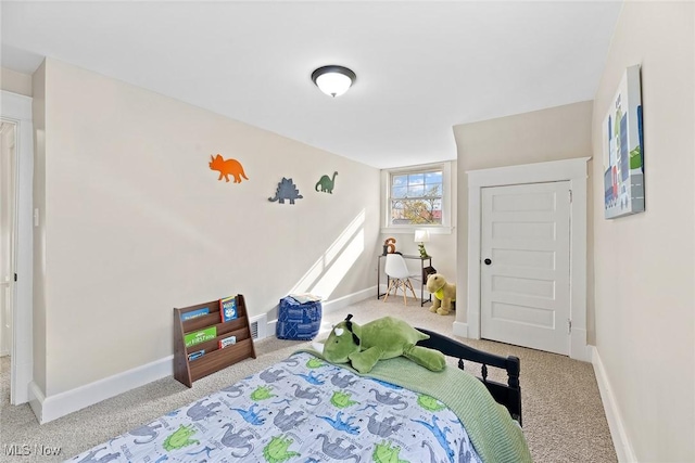 carpeted bedroom featuring baseboards