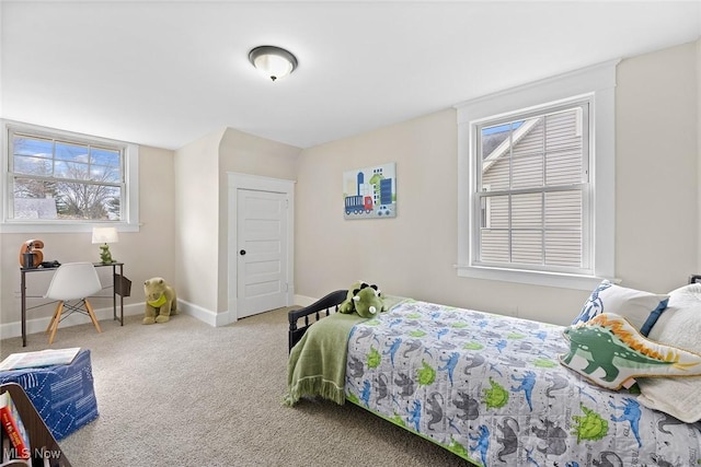 bedroom featuring baseboards, multiple windows, and carpet floors
