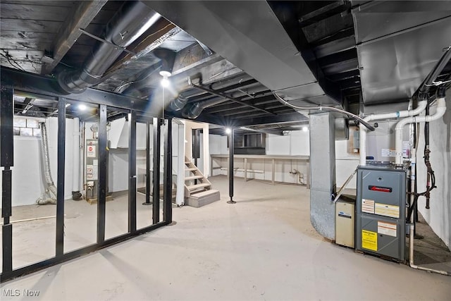 below grade area featuring water heater and stairway