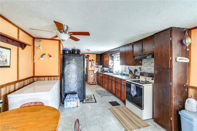kitchen featuring under cabinet range hood, a textured ceiling, a ceiling fan, and white electric stove