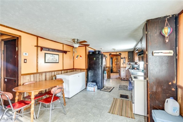 kitchen featuring freestanding refrigerator, refrigerator, a ceiling fan, white electric stove, and washer / dryer