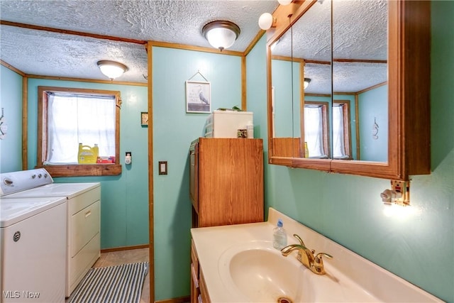 bathroom featuring washer and clothes dryer, plenty of natural light, and a textured ceiling