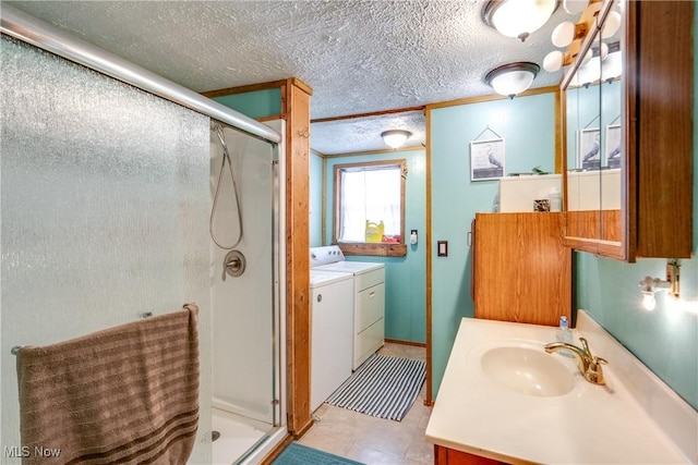 full bath with washer and dryer, a stall shower, and vanity