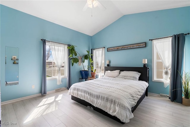 bedroom featuring light wood-style floors, ceiling fan, baseboards, and lofted ceiling
