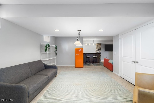 carpeted living room featuring recessed lighting, baseboards, and bar