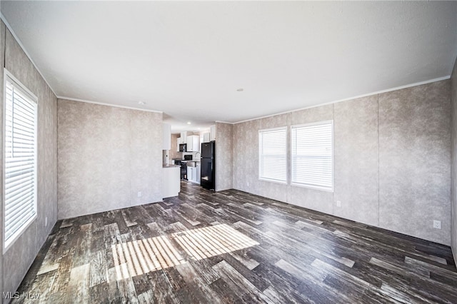 53 Martha Dr, Madison, OH 44057 - unfurnished living room featuring dark wood-style flooring and a healthy amount of sunlight