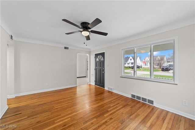 unfurnished room featuring visible vents, ceiling fan, light wood-style floors, and baseboards