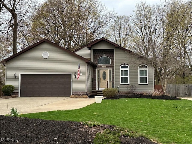 traditional-style home with fence, a garage, a front yard, and concrete driveway