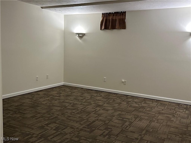 unfurnished room featuring baseboards