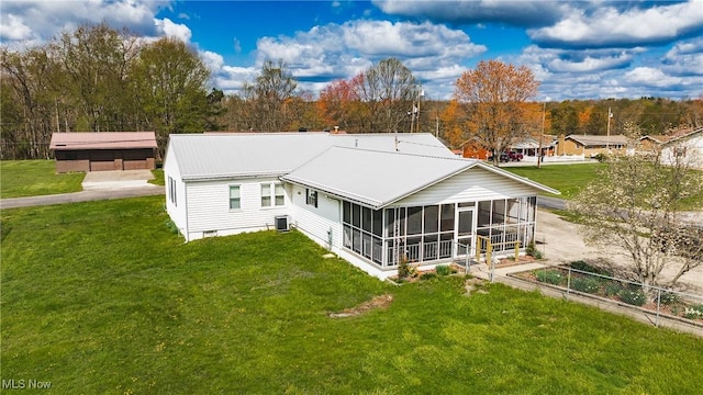 304 Conger Rd, Washington, WV 26181 - back of property featuring a sunroom, metal roof, central air condition unit, and a lawn