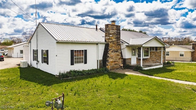 304 Conger Rd, Washington, WV 26181 - back of house with a yard, stone siding, covered porch, a chimney, and central air condition unit