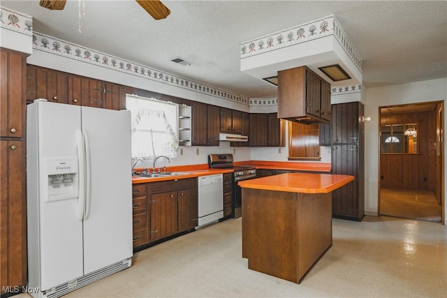304 Conger Rd, Washington, WV 26181 - kitchen with visible vents, a sink, white appliances, under cabinet range hood, and light floors