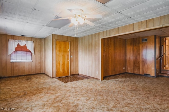 304 Conger Rd, Washington, WV 26181 - empty room featuring ceiling fan, carpet, visible vents, wooden walls, and baseboards