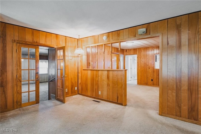 304 Conger Rd, Washington, WV 26181 - carpeted empty room with french doors, wood walls, and visible vents